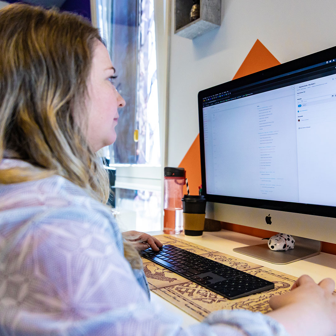 An image of the BurstingBox team working at their desk.