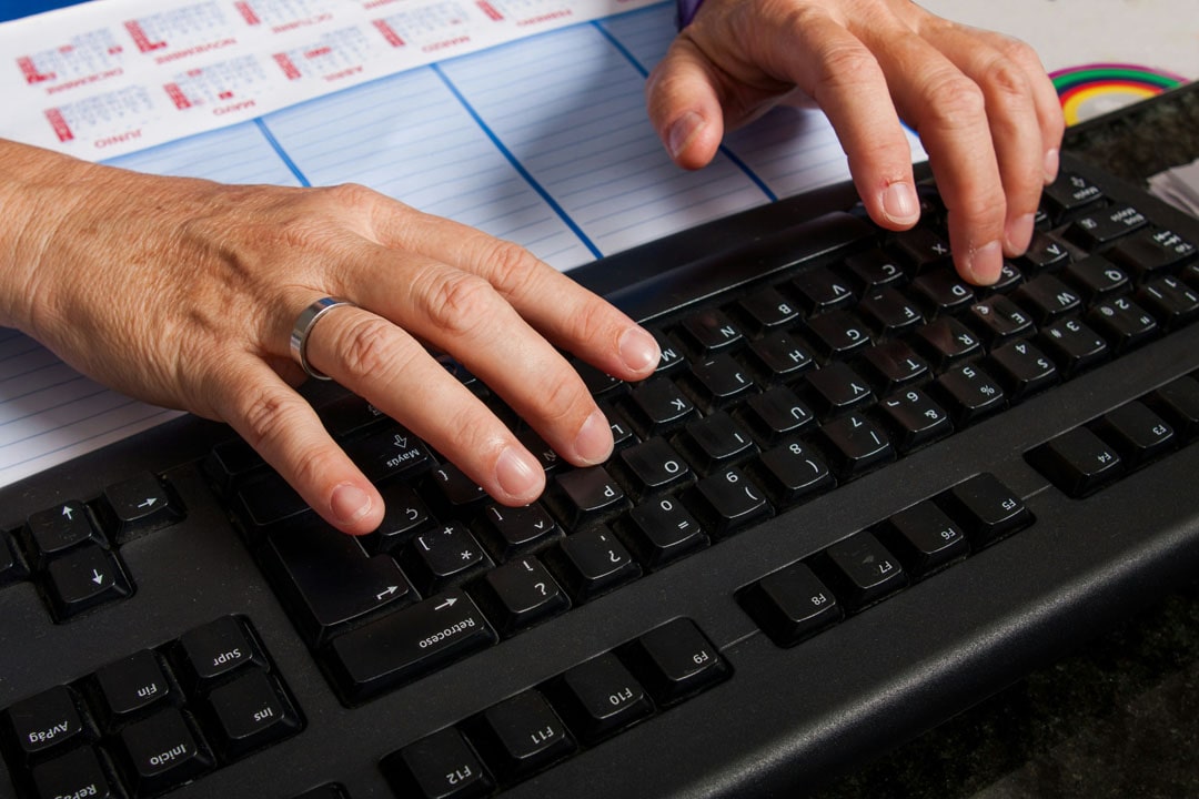 An image of someone typing up a articles on a computer.