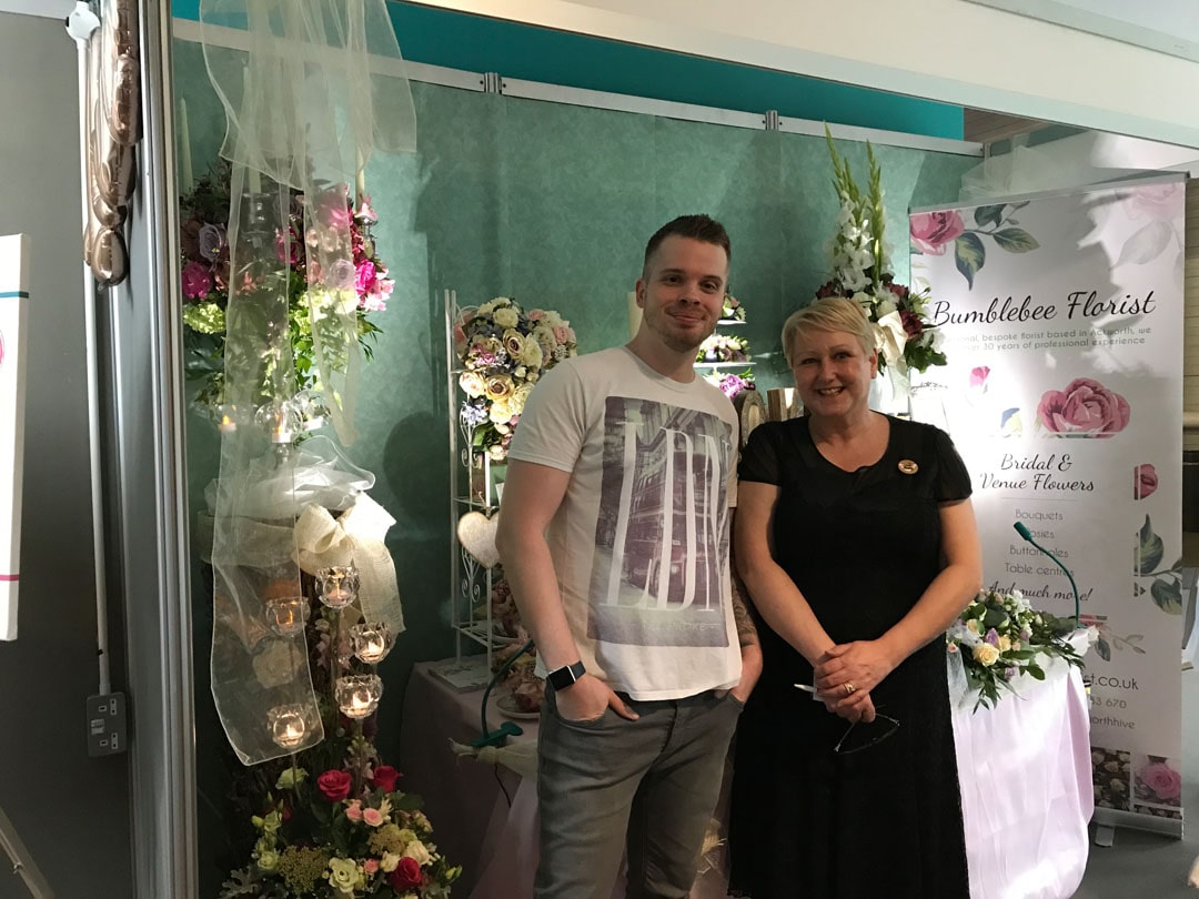 An image of Gav and a client at a wedding show.
