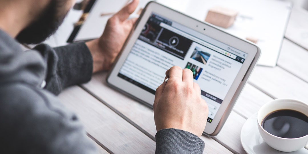 An image of someone reading articles on a tablet.