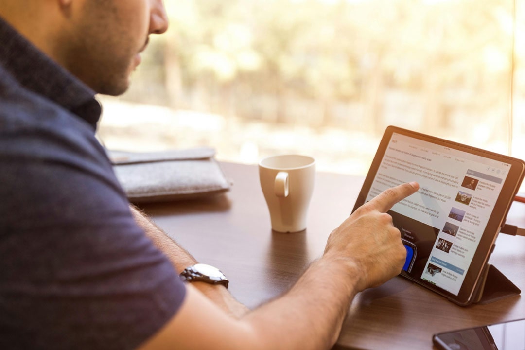 An image of a person using a website on a tablet.