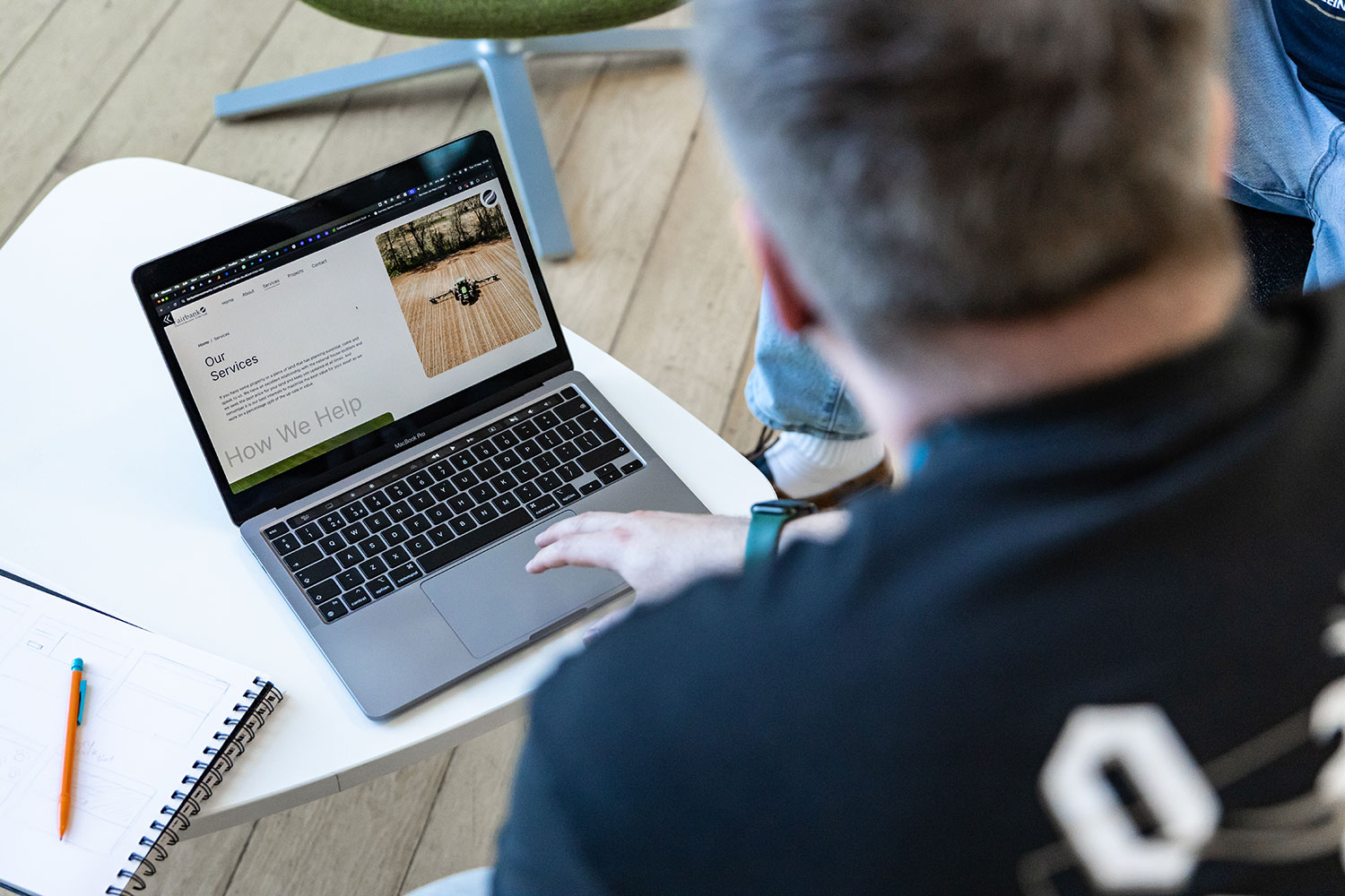 An image of a team member reviewing drawn website concepts.