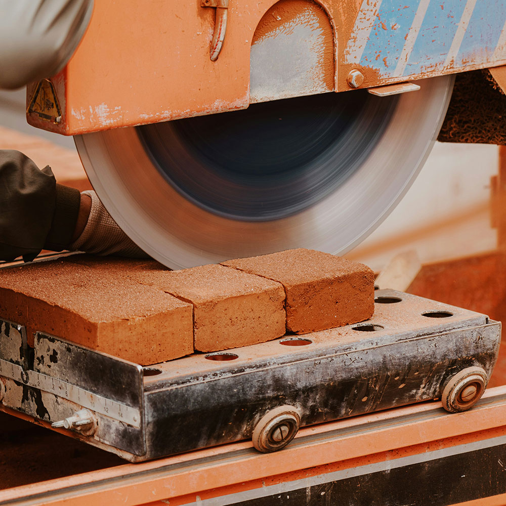 An image of someone cutting bricks.