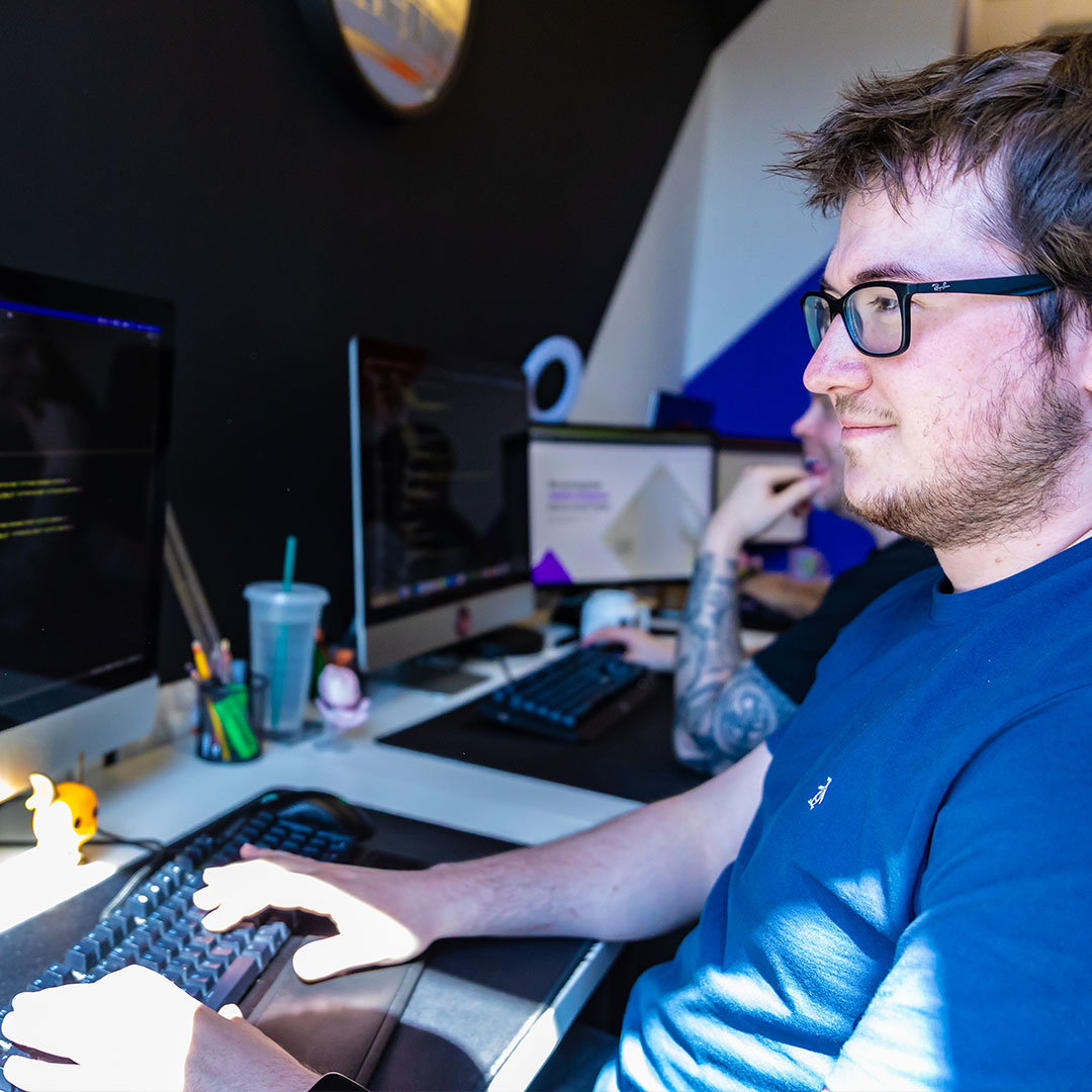 Chris at BurstingBox working on social media content.